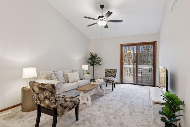 living room featuring carpet floors, a ceiling fan, visible vents, and baseboards