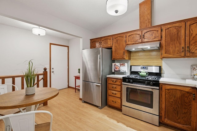 kitchen featuring brown cabinetry, appliances with stainless steel finishes, and under cabinet range hood