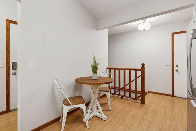 dining area with baseboards and light wood-style floors