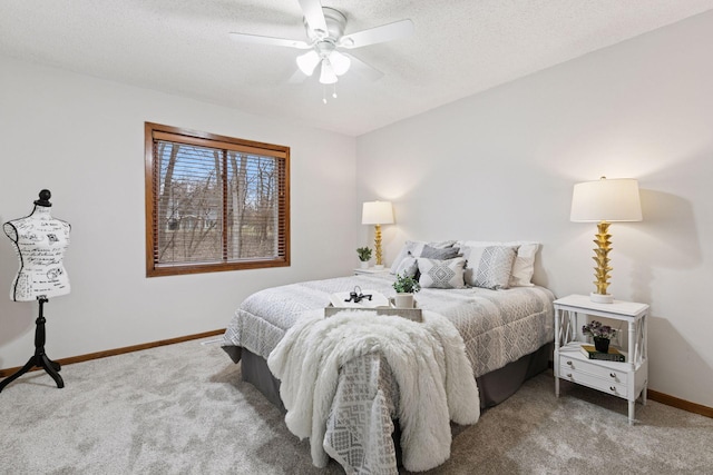 carpeted bedroom featuring baseboards, a textured ceiling, and ceiling fan
