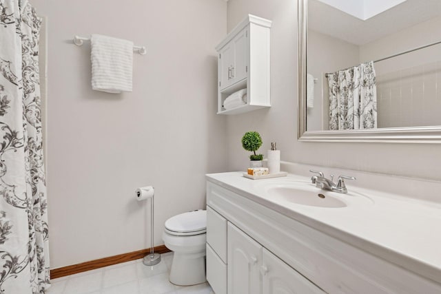 bathroom with toilet, baseboards, a skylight, curtained shower, and vanity