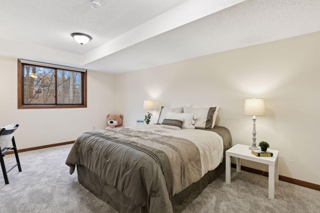 bedroom with baseboards, carpet flooring, and a textured ceiling