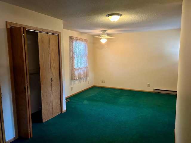 unfurnished bedroom with dark carpet, ceiling fan, a textured ceiling, baseboard heating, and a closet