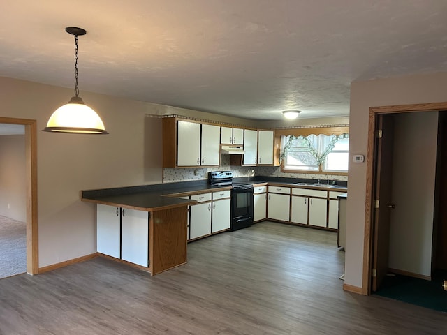 kitchen with black range with electric stovetop, white cabinets, hardwood / wood-style floors, and kitchen peninsula