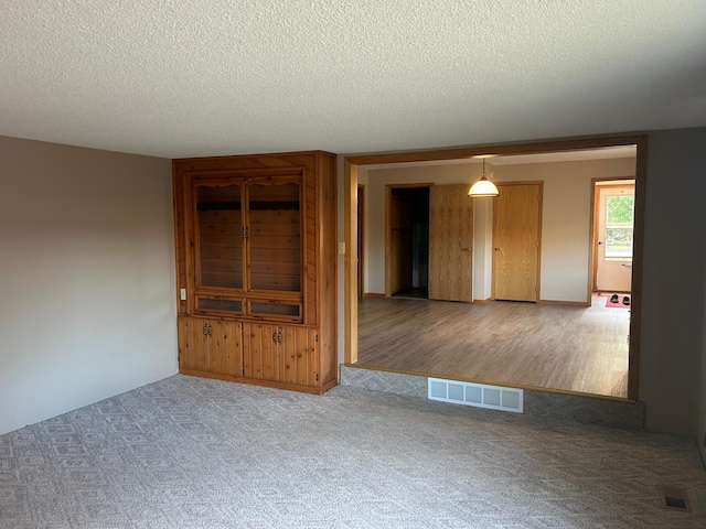 interior space with wood-type flooring and a textured ceiling