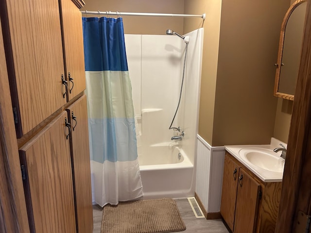 bathroom with vanity, shower / bathtub combination with curtain, and hardwood / wood-style flooring