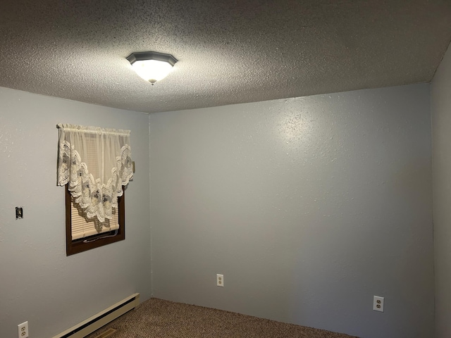 carpeted empty room featuring a textured ceiling and a baseboard heating unit