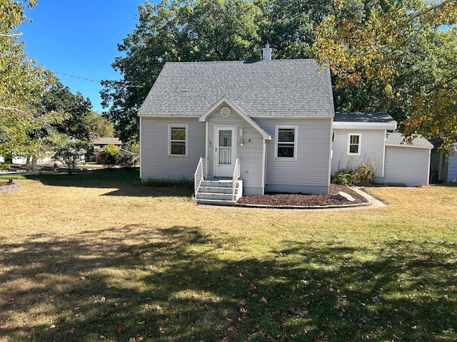 view of front of property with a storage shed and a front yard