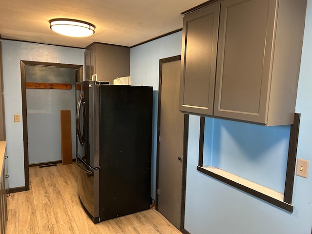 kitchen featuring light hardwood / wood-style flooring and stainless steel fridge