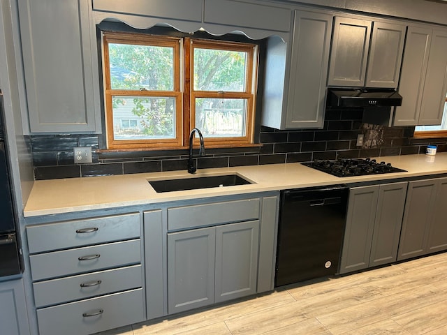 kitchen featuring gray cabinetry, sink, and black appliances