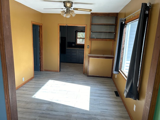 spare room with ceiling fan and light hardwood / wood-style floors