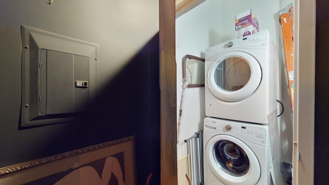 washroom featuring stacked washer / dryer and electric panel