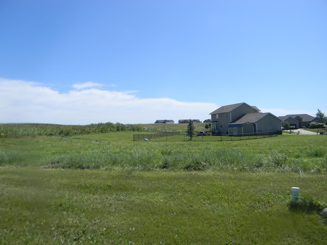 view of yard with a rural view and fence