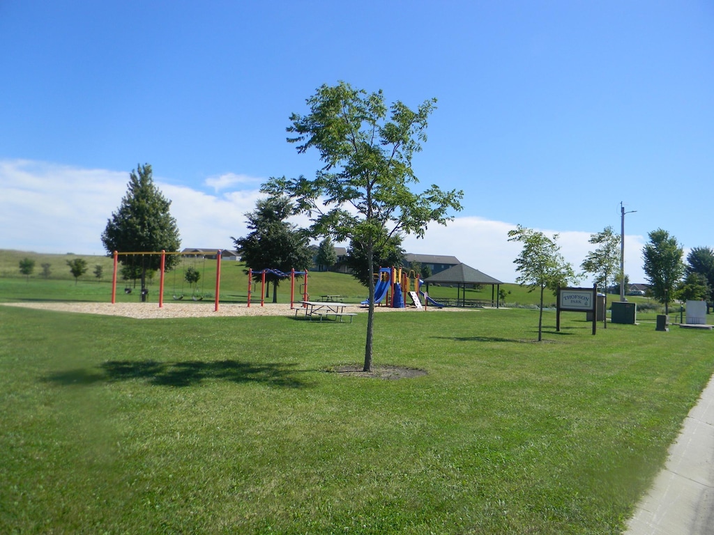 view of community with a playground and a yard