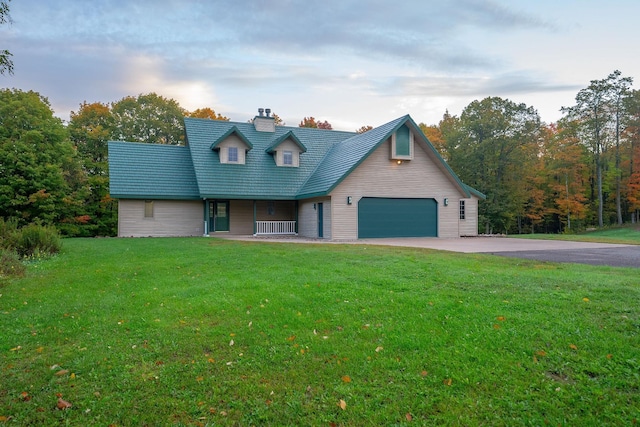 new england style home with a garage and a front lawn