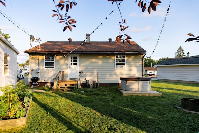 rear view of house featuring a lawn