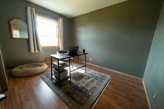 office with dark hardwood / wood-style flooring