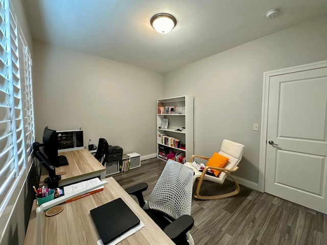 home office with dark hardwood / wood-style floors