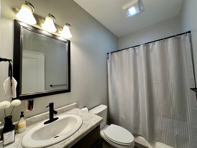 bathroom featuring vanity, toilet, a shower with shower curtain, and vaulted ceiling