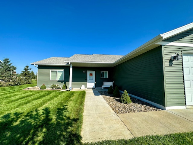 exterior space with a garage and a yard