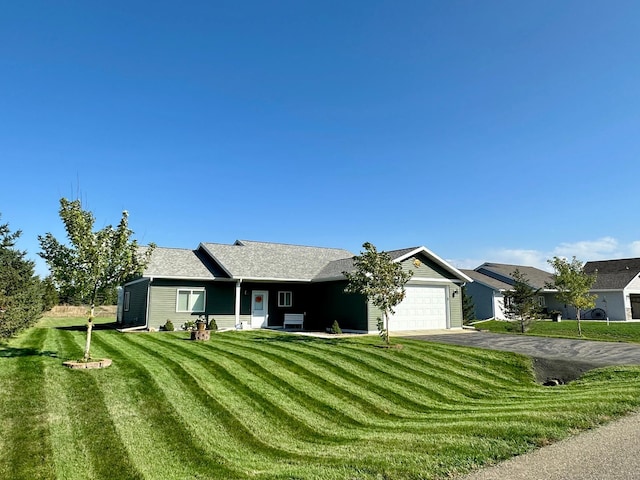 single story home with a front lawn and a garage