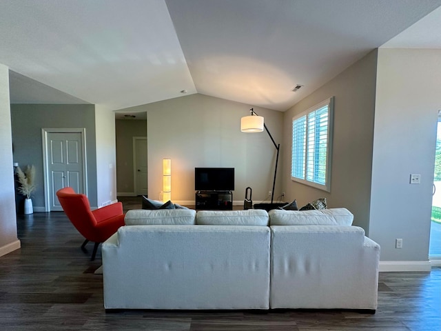 living room featuring vaulted ceiling and dark hardwood / wood-style flooring