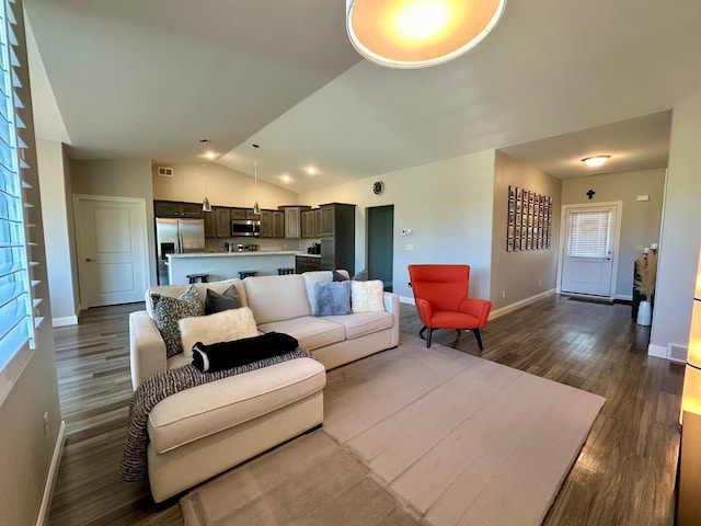 living room featuring lofted ceiling and dark hardwood / wood-style flooring