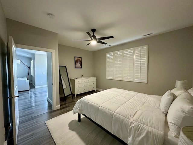 bedroom with ceiling fan and dark hardwood / wood-style flooring