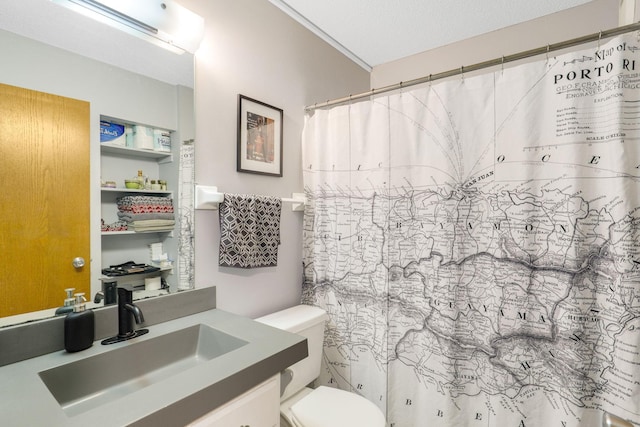 bathroom with a textured ceiling, vanity, toilet, and curtained shower