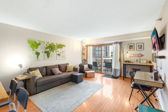 living room featuring a textured ceiling and light hardwood / wood-style flooring