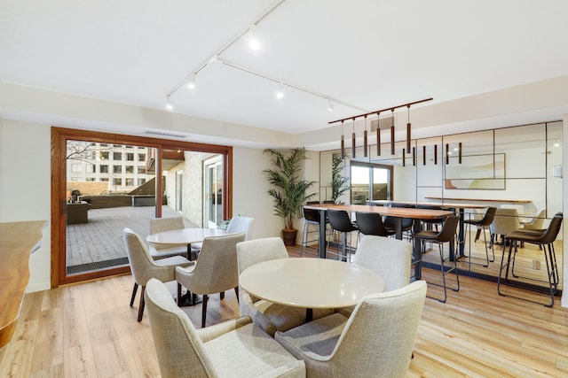 dining space featuring light wood-type flooring