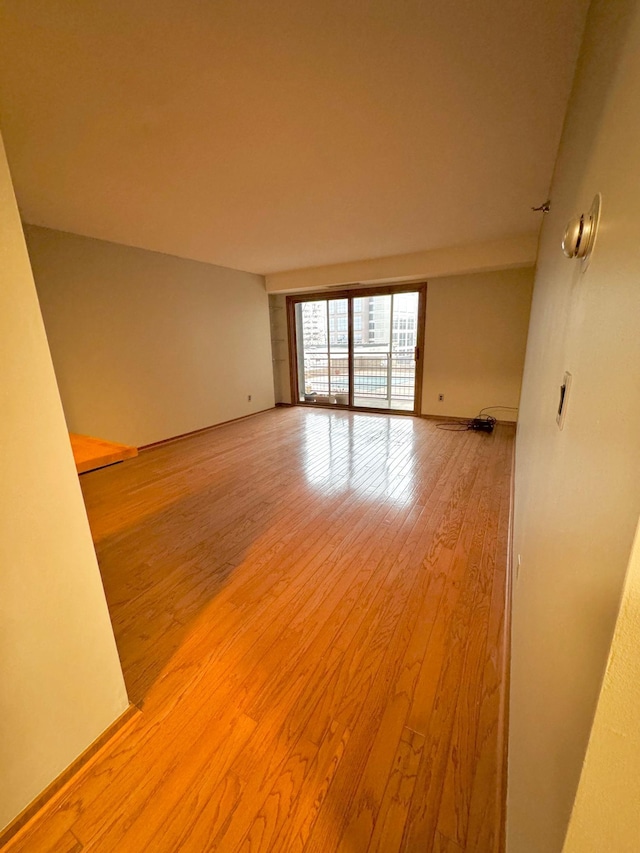 spare room with light hardwood / wood-style flooring