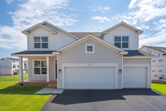 view of front of property featuring a front yard and a garage