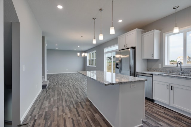 kitchen featuring stainless steel appliances, white cabinets, dark hardwood / wood-style floors, and sink