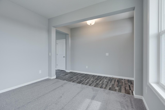 spare room featuring dark wood-type flooring