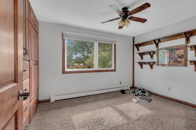 workout area with carpet floors, ceiling fan, and baseboard heating