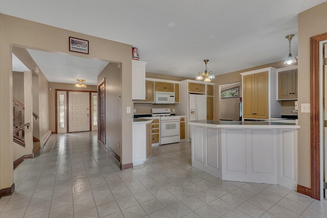 kitchen with sink, an inviting chandelier, decorative light fixtures, a center island, and white appliances