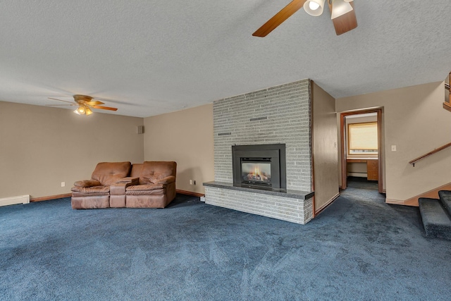 living room with dark colored carpet, a textured ceiling, a baseboard radiator, ceiling fan, and a fireplace