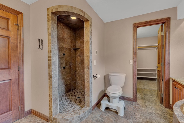 bathroom featuring toilet and tiled shower