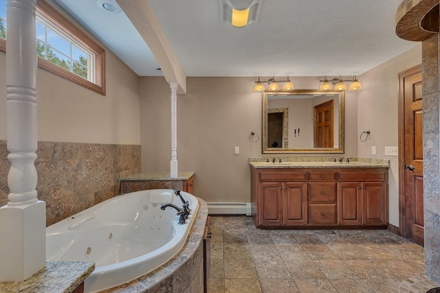 bathroom featuring vanity, tiled tub, and baseboard heating