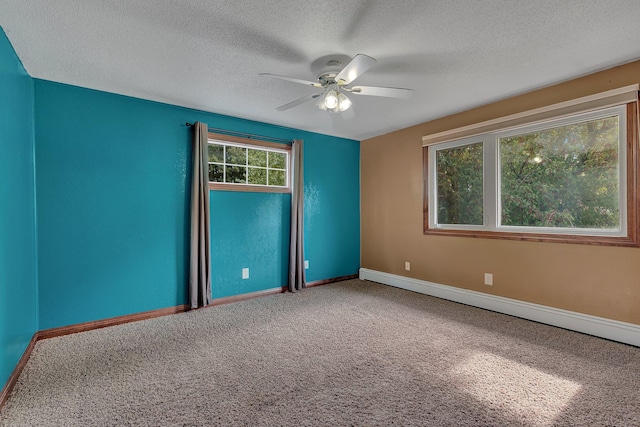 unfurnished room with ceiling fan, carpet floors, a textured ceiling, and a baseboard heating unit