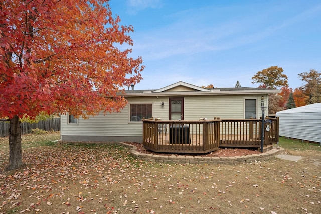 rear view of property with a wooden deck