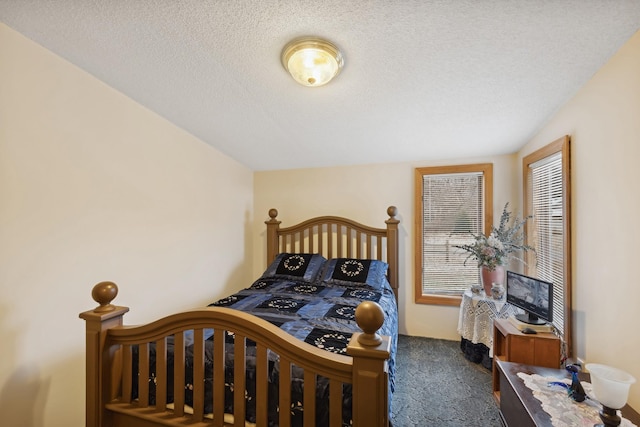 carpeted bedroom with a textured ceiling