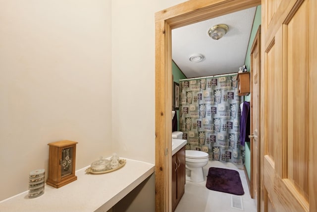 bathroom with toilet, a textured ceiling, walk in shower, and vanity