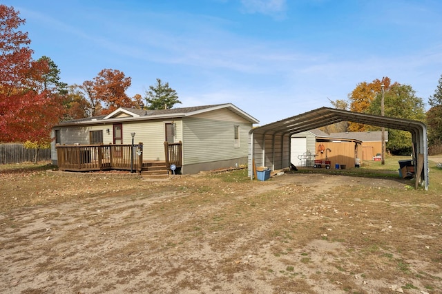 back of house featuring a carport and a wooden deck