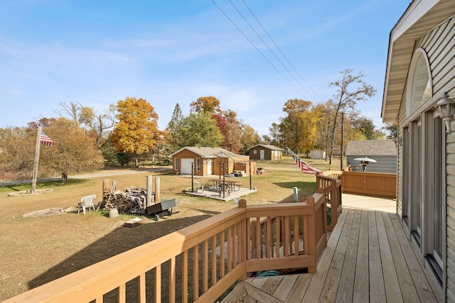 wooden terrace with a lawn and a storage unit