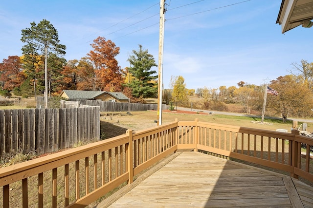 wooden deck featuring a lawn