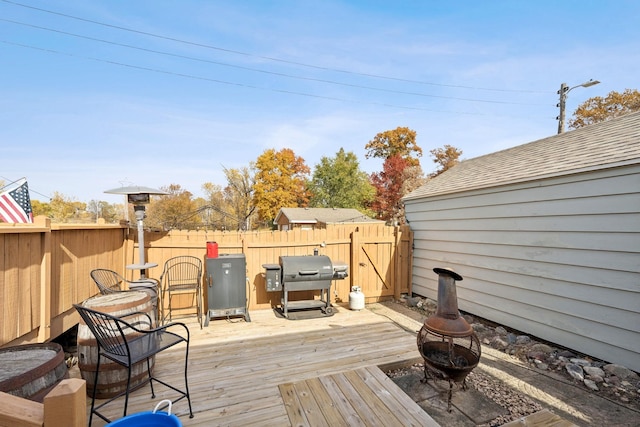 deck featuring an outdoor fire pit and grilling area