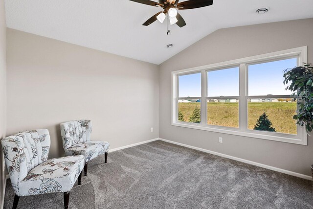 sitting room with carpet floors, vaulted ceiling, and ceiling fan