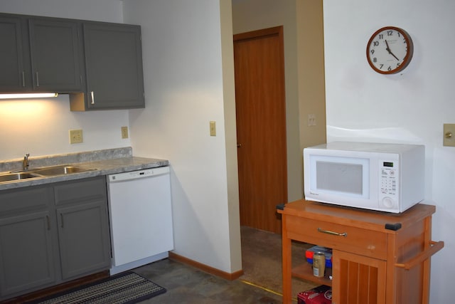 kitchen featuring gray cabinets, white appliances, and sink